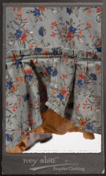 Bertie Jacket in New Sun Softest Knit; Floravinea Brooch in Rosy Washed Crinkled Linen; Tilbrook Frock in Fresh Water Floral Weave; Edenshire Frock in New Sun Washed Linen in High Water Length; Porte Cochere Sash in Rosy Washed Cotton. By Ivey Abitz.