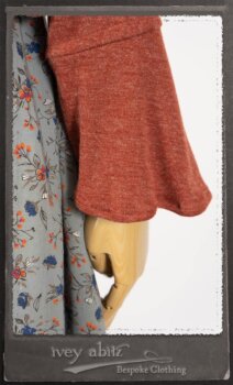 Bertie Jacket in New Sun Softest Knit; Floravinea Brooch in Rosy Washed Crinkled Linen; Tilbrook Frock in Fresh Water Floral Weave; Edenshire Frock in New Sun Washed Linen in High Water Length; Porte Cochere Sash in Rosy Washed Cotton. By Ivey Abitz.