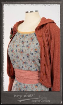 Bertie Jacket in New Sun Softest Knit; Floravinea Brooch in Rosy Washed Crinkled Linen; Tilbrook Frock in Fresh Water Floral Weave; Edenshire Frock in New Sun Washed Linen in High Water Length; Porte Cochere Sash in Rosy Washed Cotton. By Ivey Abitz.