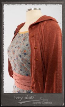 Bertie Jacket in New Sun Softest Knit; Floravinea Brooch in Rosy Washed Crinkled Linen; Tilbrook Frock in Fresh Water Floral Weave; Edenshire Frock in New Sun Washed Linen in High Water Length; Porte Cochere Sash in Rosy Washed Cotton. By Ivey Abitz.
