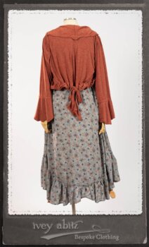 Bertie Jacket in New Sun Softest Knit; Floravinea Brooch in Rosy Washed Crinkled Linen; Tilbrook Frock in Fresh Water Floral Weave; Edenshire Frock in New Sun Washed Linen in High Water Length; Porte Cochere Sash in Rosy Washed Cotton. By Ivey Abitz.