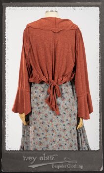 Bertie Jacket in New Sun Softest Knit; Floravinea Brooch in Rosy Washed Crinkled Linen; Tilbrook Frock in Fresh Water Floral Weave; Edenshire Frock in New Sun Washed Linen in High Water Length; Porte Cochere Sash in Rosy Washed Cotton. By Ivey Abitz.