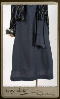 Chevallier Cardigan in Fresh Water Rustic Argyle Knit; Vanetten Frock in Fresh Water Petite Fleur Cotton; Vanetten Sash in Fresh Water Petite Fleur Cotton. By Ivey Abitz.