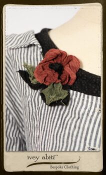 Campanella Shirt Jacket in Black and White Petite Stripe Linen; Bertie Frock in Black Puckered Check Weave; Cilla Slip Frock in Signature Black Lightweight Linen Knit; Floravinea Brooch in Rosy Washed Crinkled Linen. By Ivey Abitz.