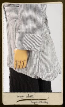 Campanella Shirt Jacket in Black and White Petite Stripe Linen; Bertie Frock in Black Puckered Check Weave; Cilla Slip Frock in Signature Black Lightweight Linen Knit; Floravinea Brooch in Rosy Washed Crinkled Linen. By Ivey Abitz.