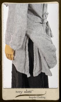 Campanella Shirt Jacket in Black and White Petite Stripe Linen; Bertie Frock in Black Puckered Check Weave; Cilla Slip Frock in Signature Black Lightweight Linen Knit; Floravinea Brooch in Rosy Washed Crinkled Linen. By Ivey Abitz.