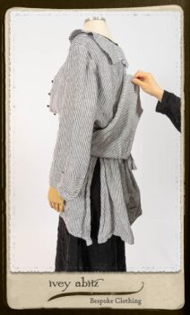 Campanella Shirt Jacket in Black and White Petite Stripe Linen; Bertie Frock in Black Puckered Check Weave; Cilla Slip Frock in Signature Black Lightweight Linen Knit; Floravinea Brooch in Rosy Washed Crinkled Linen. By Ivey Abitz.