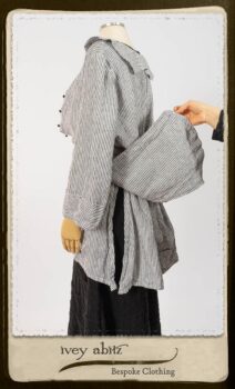 Campanella Shirt Jacket in Black and White Petite Stripe Linen; Bertie Frock in Black Puckered Check Weave; Cilla Slip Frock in Signature Black Lightweight Linen Knit; Floravinea Brooch in Rosy Washed Crinkled Linen. By Ivey Abitz.