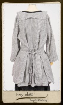 Campanella Shirt Jacket in Black and White Petite Stripe Linen; Bertie Frock in Black Puckered Check Weave; Cilla Slip Frock in Signature Black Lightweight Linen Knit; Floravinea Brooch in Rosy Washed Crinkled Linen. By Ivey Abitz.