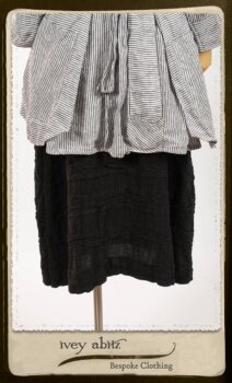 Campanella Shirt Jacket in Black and White Petite Stripe Linen; Bertie Frock in Black Puckered Check Weave; Cilla Slip Frock in Signature Black Lightweight Linen Knit; Floravinea Brooch in Rosy Washed Crinkled Linen. By Ivey Abitz.