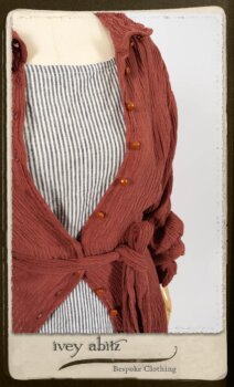 Scattergood Duster Coat in Rosy Washed Crinkled Linen; Scattergood Frock in Black and White Petite Stripe Linen; Floravinea Brooch in Rosy Washed Crinkled Linen. By Ivey Abitz.