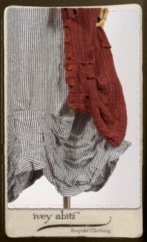 Scattergood Duster Coat in Rosy Washed Crinkled Linen; Scattergood Frock in Black and White Petite Stripe Linen; Floravinea Brooch in Rosy Washed Crinkled Linen. By Ivey Abitz.