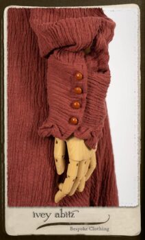 Scattergood Duster Coat in Rosy Washed Crinkled Linen; Scattergood Frock in Black and White Petite Stripe Linen; Floravinea Brooch in Rosy Washed Crinkled Linen. By Ivey Abitz.