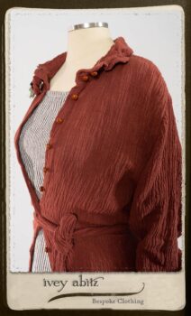 Scattergood Duster Coat in Rosy Washed Crinkled Linen; Scattergood Frock in Black and White Petite Stripe Linen; Floravinea Brooch in Rosy Washed Crinkled Linen. By Ivey Abitz.