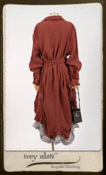 Scattergood Duster Coat in Rosy Washed Crinkled Linen; Scattergood Frock in Black and White Petite Stripe Linen; Floravinea Brooch in Rosy Washed Crinkled Linen. By Ivey Abitz.