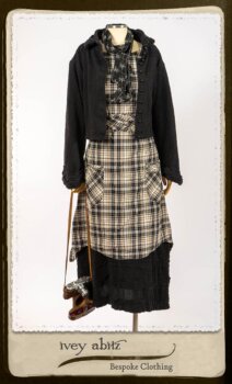 Bramley Frock in Black and White Picture Book Plaid; Clotaire Sash in White on Black Floral Silk Chiffon; Bertie Jacket in Black Floral Raised Knit; Bertie Frock in Black Puckered Check Weave. By Ivey Abitz.