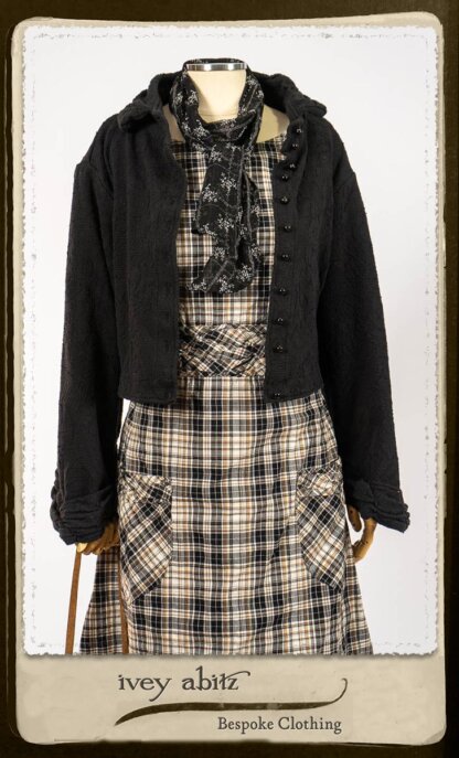 Bramley Frock in Black and White Picture Book Plaid; Clotaire Sash in White on Black Floral Silk Chiffon; Bertie Jacket in Black Floral Raised Knit; Bertie Frock in Black Puckered Check Weave. By Ivey Abitz.