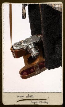 Bramley Frock in Black and White Picture Book Plaid; Clotaire Sash in White on Black Floral Silk Chiffon; Bertie Jacket in Black Floral Raised Knit; Bertie Frock in Black Puckered Check Weave. By Ivey Abitz.