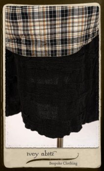 Bramley Frock in Black and White Picture Book Plaid; Clotaire Sash in White on Black Floral Silk Chiffon; Bertie Jacket in Black Floral Raised Knit; Bertie Frock in Black Puckered Check Weave. By Ivey Abitz.