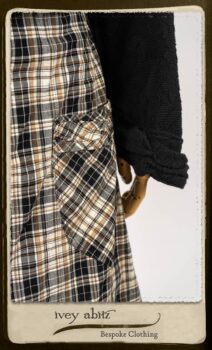 Bramley Frock in Black and White Picture Book Plaid; Clotaire Sash in White on Black Floral Silk Chiffon; Bertie Jacket in Black Floral Raised Knit; Bertie Frock in Black Puckered Check Weave. By Ivey Abitz.