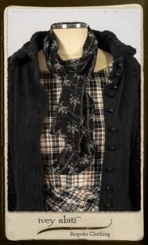 Bramley Frock in Black and White Picture Book Plaid; Clotaire Sash in White on Black Floral Silk Chiffon; Bertie Jacket in Black Floral Raised Knit; Bertie Frock in Black Puckered Check Weave. By Ivey Abitz.