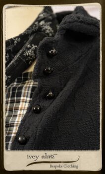 Bramley Frock in Black and White Picture Book Plaid; Clotaire Sash in White on Black Floral Silk Chiffon; Bertie Jacket in Black Floral Raised Knit; Bertie Frock in Black Puckered Check Weave. By Ivey Abitz.