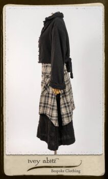 Bramley Frock in Black and White Picture Book Plaid; Clotaire Sash in White on Black Floral Silk Chiffon; Bertie Jacket in Black Floral Raised Knit; Bertie Frock in Black Puckered Check Weave. By Ivey Abitz.
