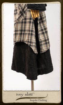 Bramley Frock in Black and White Picture Book Plaid; Clotaire Sash in White on Black Floral Silk Chiffon; Bertie Jacket in Black Floral Raised Knit; Bertie Frock in Black Puckered Check Weave. By Ivey Abitz.