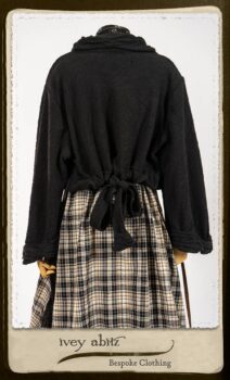 Bramley Frock in Black and White Picture Book Plaid; Clotaire Sash in White on Black Floral Silk Chiffon; Bertie Jacket in Black Floral Raised Knit; Bertie Frock in Black Puckered Check Weave. By Ivey Abitz.
