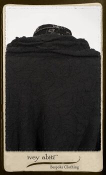 Bramley Frock in Black and White Picture Book Plaid; Clotaire Sash in White on Black Floral Silk Chiffon; Bertie Jacket in Black Floral Raised Knit; Bertie Frock in Black Puckered Check Weave. By Ivey Abitz.