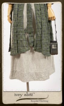 Campanella Overlay in New Day Washed Plaid Gauze; Addy Jacket in Signature Black Lightweight Linen Knit; Campanella Frock in New Day Washed Stripe Linen. By Ivey Abitz.