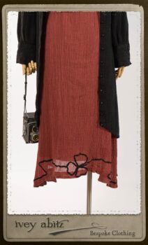 Truitt Shirt Jacket in Black Puckered Check Weave; Monceau Frock in Rosy Washed Crinkled Linen; Cilla Slip Frock in Signature Black Lightweight Linen Knit with Square Collar; Clotaire Sash in Rosy Washed Crinkled Linen. By Ivey Abitz.