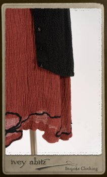 Truitt Shirt Jacket in Black Puckered Check Weave; Monceau Frock in Rosy Washed Crinkled Linen; Cilla Slip Frock in Signature Black Lightweight Linen Knit with Square Collar; Clotaire Sash in Rosy Washed Crinkled Linen. By Ivey Abitz.