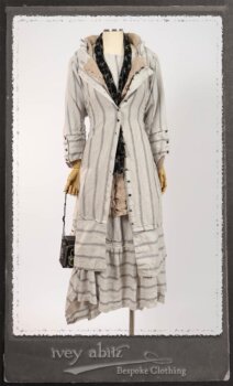 Harrison Duster Coat in Black and White Picture Book Stripe; Harrison Shirt Jacket in Picture Book Washed Crinkled Linen; Clotaire Sash in White on Black Floral Silk Chiffon; Fairholme Frock in Black and White Picture Book Stripe. By Ivey Abitz.