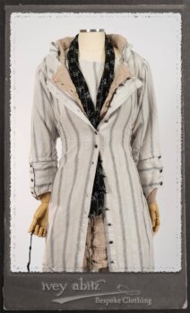 Harrison Duster Coat in Black and White Picture Book Stripe; Harrison Shirt Jacket in Picture Book Washed Crinkled Linen; Clotaire Sash in White on Black Floral Silk Chiffon; Fairholme Frock in Black and White Picture Book Stripe. By Ivey Abitz.