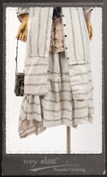 Harrison Duster Coat in Black and White Picture Book Stripe; Harrison Shirt Jacket in Picture Book Washed Crinkled Linen; Clotaire Sash in White on Black Floral Silk Chiffon; Fairholme Frock in Black and White Picture Book Stripe. By Ivey Abitz.