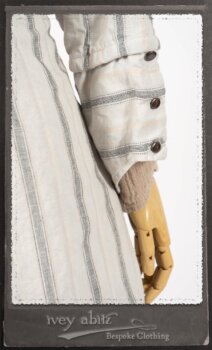 Harrison Duster Coat in Black and White Picture Book Stripe; Harrison Shirt Jacket in Picture Book Washed Crinkled Linen; Clotaire Sash in White on Black Floral Silk Chiffon; Fairholme Frock in Black and White Picture Book Stripe. By Ivey Abitz.