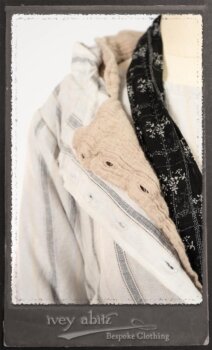 Harrison Duster Coat in Black and White Picture Book Stripe; Harrison Shirt Jacket in Picture Book Washed Crinkled Linen; Clotaire Sash in White on Black Floral Silk Chiffon; Fairholme Frock in Black and White Picture Book Stripe. By Ivey Abitz.