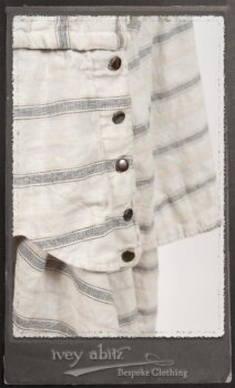 Harrison Duster Coat in Black and White Picture Book Stripe; Harrison Shirt Jacket in Picture Book Washed Crinkled Linen; Clotaire Sash in White on Black Floral Silk Chiffon; Fairholme Frock in Black and White Picture Book Stripe. By Ivey Abitz.