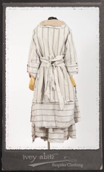 Harrison Duster Coat in Black and White Picture Book Stripe; Harrison Shirt Jacket in Picture Book Washed Crinkled Linen; Clotaire Sash in White on Black Floral Silk Chiffon; Fairholme Frock in Black and White Picture Book Stripe. By Ivey Abitz.