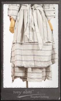 Harrison Duster Coat in Black and White Picture Book Stripe; Harrison Shirt Jacket in Picture Book Washed Crinkled Linen; Clotaire Sash in White on Black Floral Silk Chiffon; Fairholme Frock in Black and White Picture Book Stripe. By Ivey Abitz.