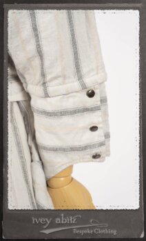 Harrison Duster Coat in Black and White Picture Book Stripe; Harrison Shirt Jacket in Picture Book Washed Crinkled Linen; Clotaire Sash in White on Black Floral Silk Chiffon; Fairholme Frock in Black and White Picture Book Stripe. By Ivey Abitz.