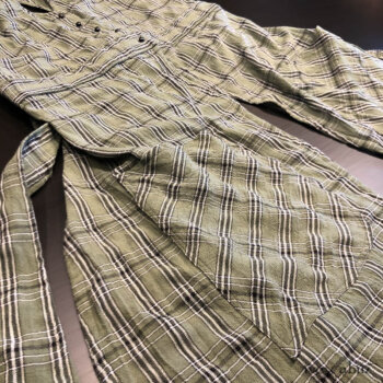 Campanella Overlay in New Day Washed Plaid Gauze, adorned with antique wooden composition buttons, circa early 1900's.