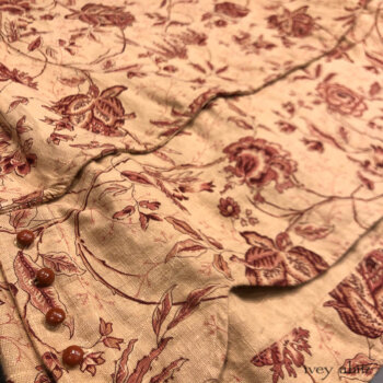 Harrison Frock in Rosy Washed Floral Linen. Adorned with antique wooden composition buttons, circa early 1900's.