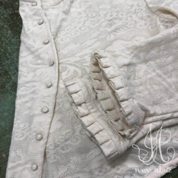 Canterbury Cardigan in Gardenia Floral Knit, adorned with antique buttons, circa early 1900&rsquo;s.