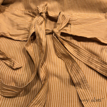 Our signature back tab and tie detail allows you to adjust the fit of our duster coats, depending on what you are wearing under it.