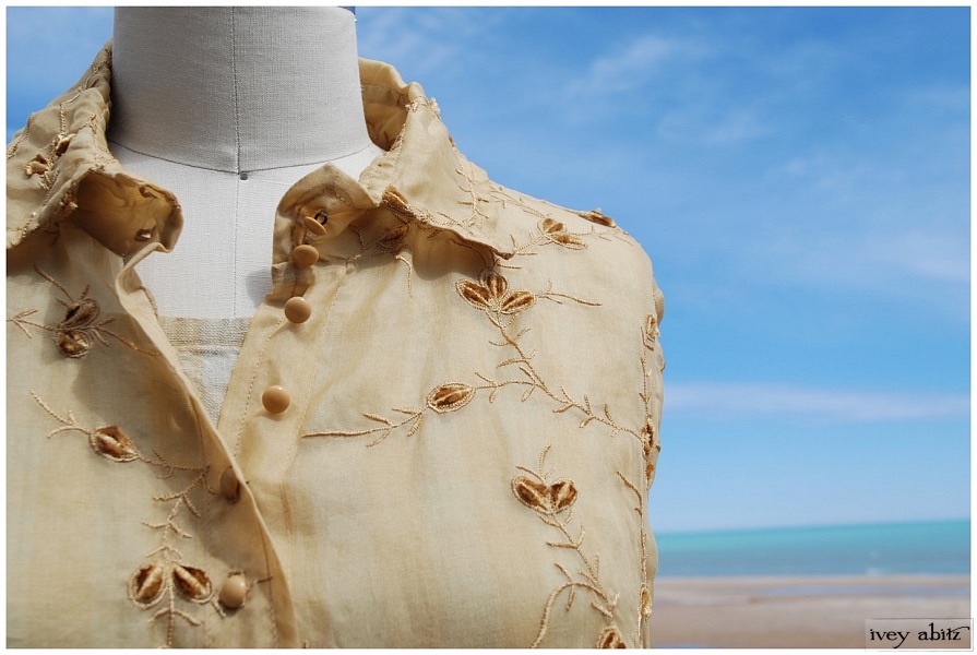 The Phinneus Coat Dress is shown in an embroidered silk organza over a plaid linen Tilbrook Frock.