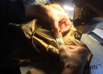 Sewing the label onto the Emmy Dress for Carolyn Hennesy, designed by Cynthia Ivey Abitz.
