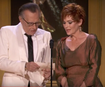 Carolyn Hennesy announcing an Emmy winner with Larry King, wearing her Ivey Abitz couture gown.