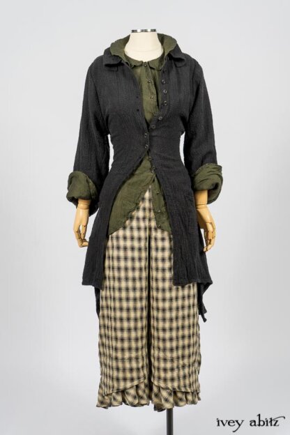 Elsie Duster Coat in Black Puckered Check Weave; Limited Edition Arthur Hill Shirt in Arthurian Green Cotton Voile; Blanchefleur Trousers in Black and Natural Plaid Weave. By Ivey Abitz